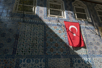 Wall Mural - Light and shadow of blue tiles and flag at Eyup Sultan mosque, Istanbul, Turkey.