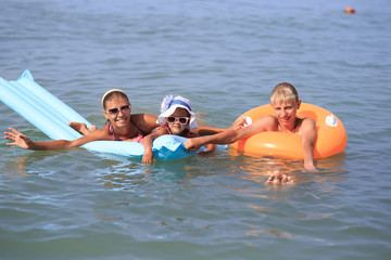 Young woman with children at sea