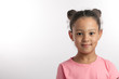 closeup portrait of an adorable girl wearing two buns isolated on the white background. copy space. children and people cocncept