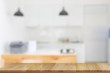 © bongkarn - Empty wooden top table in modern kitchen room background, for product or food display montage.
