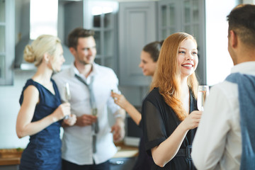 Poster - Happy girl with flute of champagne talking to her boyfriend at party on background of friends