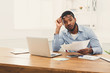 © Prostock-studio - Young black businessman working with laptop