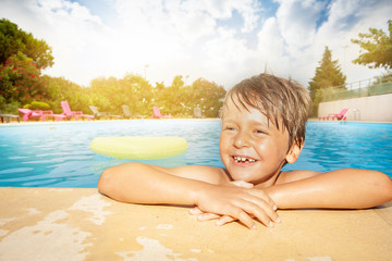 Sticker - Happy boy relaxing at the swimming pool edge