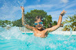 © Sergey Novikov - Boy having fun splashing water in swimming pool