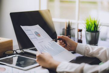 Wall Mural - The accountant checking documents about graph and chart relating to financial reporting and tax accounting of the company