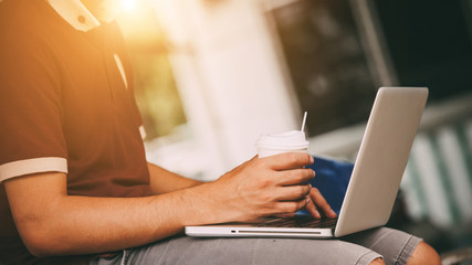 Wall Mural - Business man working on laptop computer and drinking coffee