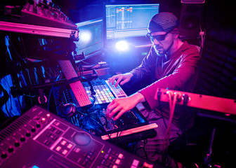 Sound engineer working at mixing panel in the in sound recording studio.