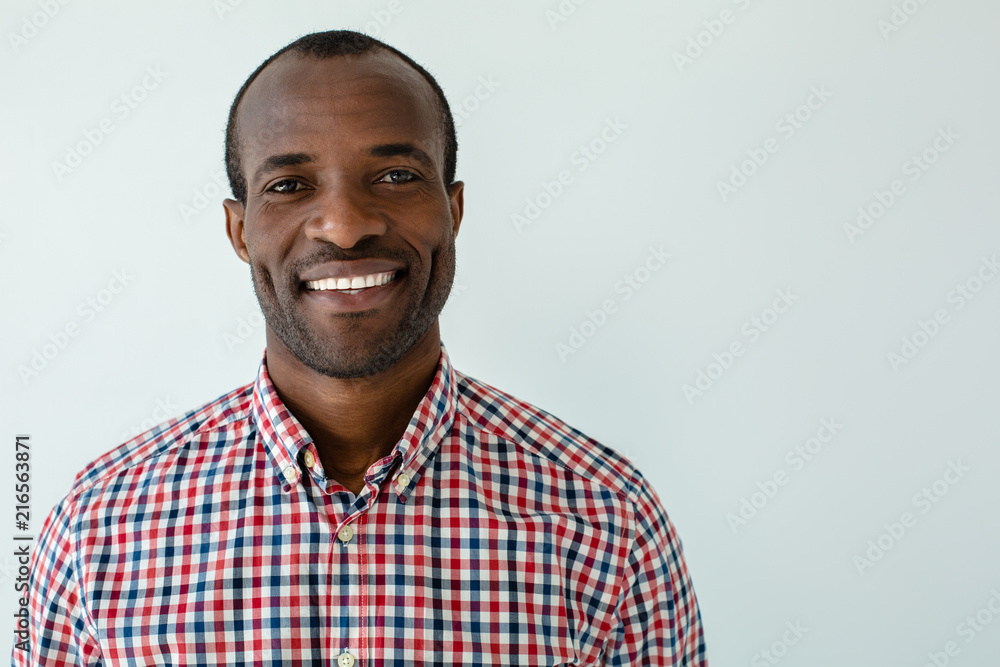 Portrait of smiling afro american man standing against white background ...