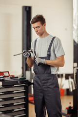 Wall Mural - A car mechanic is focused on his work