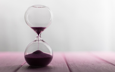 Hourglass with pink sand.