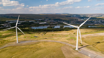 Wall Mural - Wind turbines on a rural hillside next to a large lake