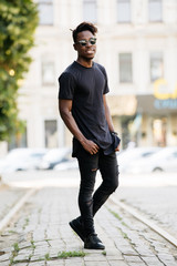 Young african man wearing black t-shirt in city street