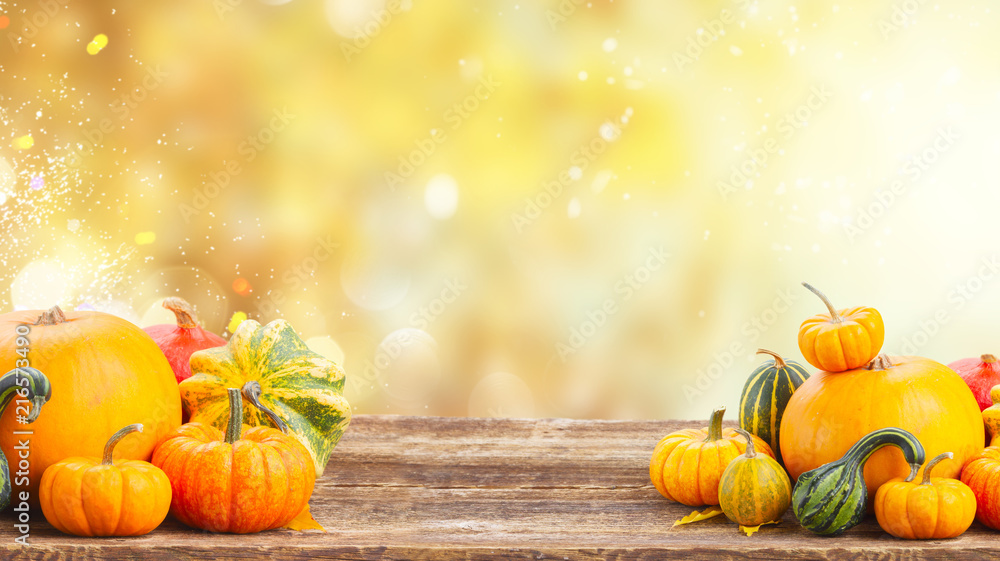 pile of orange pumpkins on wooden table over fall background banner - obrazy, fototapety, plakaty 