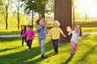 © Evgeniy Kalinovskiy - a group of small happy children run through the park in the background of grass and trees. Children's outdoor games, vacations, weekend, Children's Day, June 1