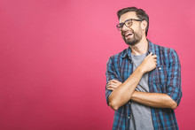 Portrait Of A Handsome Casual Man Who Laughs, Standing And Laughing Over Pink Background
