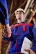 © Evgeniy Kalinovskiy - Strong handshake of men in overalls of industrial workers