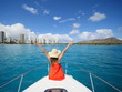 honolulu city woman welcoming from a yacht in the ocean with hand in the air