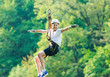 © Natali - Happy, cute, young boy in white t shirt and helmet having fun and playing at adventure park, holding ropes and climbing wooden stairs. active lifestyle concept