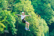 © Natali - Happy, cute, young boy in white t shirt and helmet having fun and playing at adventure park, holding ropes and climbing wooden stairs. active lifestyle concept