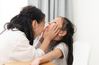 © nuiiko - Asian children playing doctor at home, girl open her mouth for checking up, kids lifestyle.