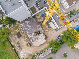 yellow tower crane for construction of new high-rise apartment building. aerial top view