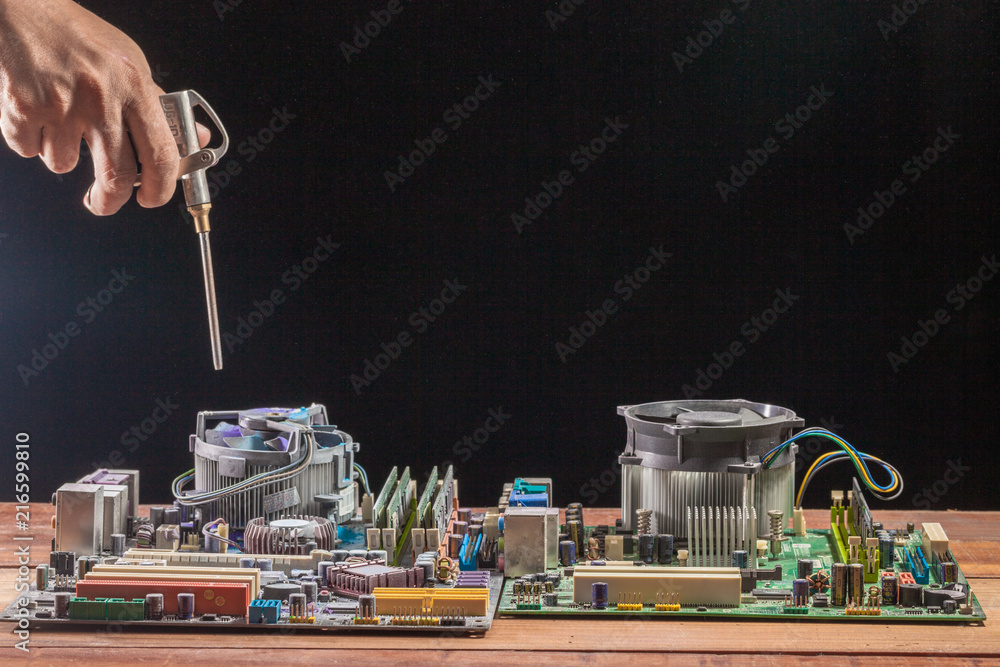 Computer Compraser computer mainboard on wooden table on black background.. using air ...