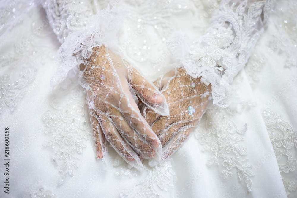Woman in white wedding dress, bride hands in white bride gloves.  Traditional Islamic hijab wedding dresses. Muslim brides who spent their  wedding day wearing the most incredible veils called hijabs. Stock Photo |