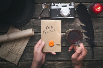 Wall Mural - top secret documents in the envelope in the hands of detective agent. security.