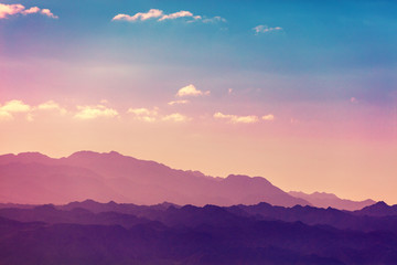 Poster - Sunset over mountains. Silhouette of a mountain range against sky at sunset