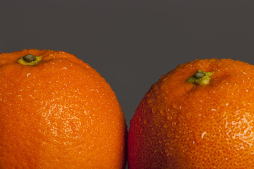 fresh orange closeup on the wood table, grey background.