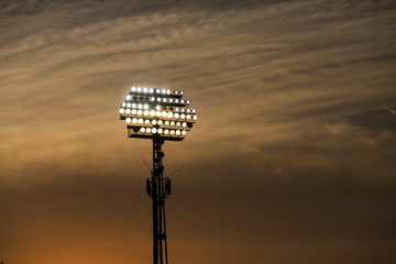 Wall Mural - Stadium lights on sunset background