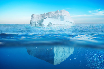 Wall Mural - underwater view of iceberg with beautiful transparent sea. hidden danger and global warming concept