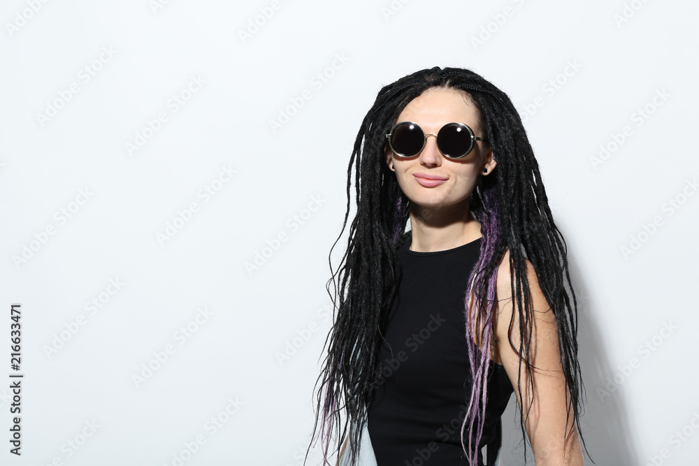 Young Woman With Dreadlocks And Sunglasses On White