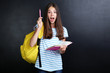 © 5second - Young girl with backpack and book on blackboard background