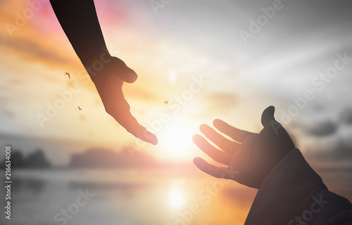 Fotomural The concept of God's salvation:silhouette of helping hand concept and internatio