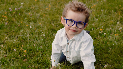 child in glasses on the grass