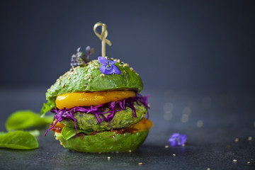 Avocado sandwich with green vegan burger,  roast yellow pepper and pickled red cabbage