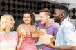 © Syda Productions - leisure and people concept - happy friends with drinks eating and talking at food truck
