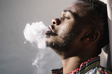 African Man Smoking White Smoke Hookah.