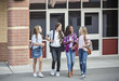 © Brocreative - Group of young female friends  and students talking together as they leave school for the day