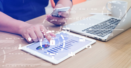 Wall Mural - Close up businessman hand typing or working on tablet and laptop for programming about cyber security , advance future technology concept