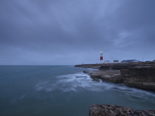 Summer Sunrise With Stormy Clouds And Slow Shutter Speed At Portland Bill Light, Dorset, UK