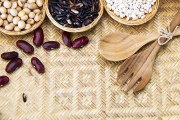 healthy food concept : organic rice and beans in hand made wicker ware 