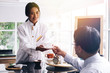 © twinsterphoto - Young Asian female barista making and giving coffee to male customer. Business man receiving coffee at cafe restaurant