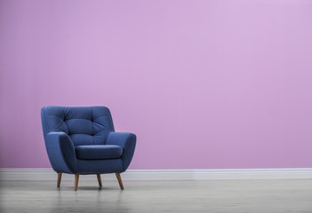 Sticker - Stylish comfortable armchair near color wall