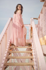 Wall Mural - Beautiful pregnant woman on the lifeguard tower