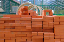 Stack Of Red Bricks For Build Construction.