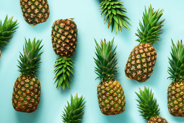 Wall Mural - fresh pineapples on blue background. top view. pop art design, creative concept. copy space. bright 
