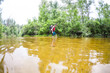 © zhukovvvlad - A man with a child crosses the river ford.