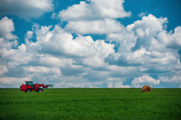 Wall Mural - Red tractor transporting straw bales